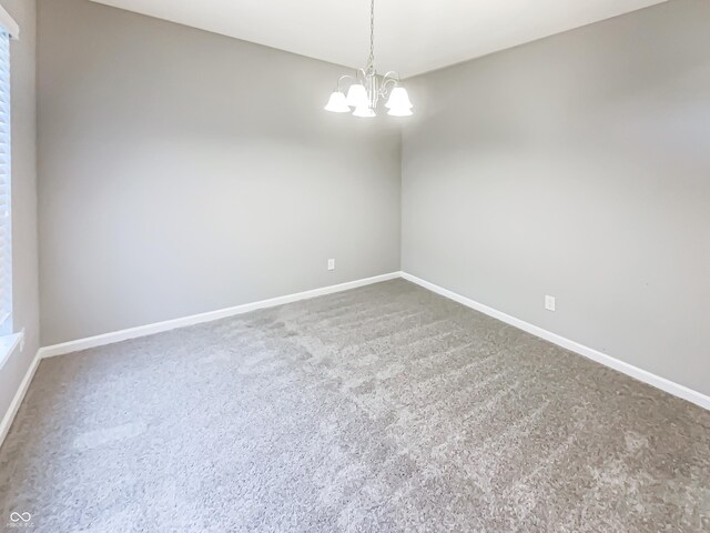 18230 Sandy Cove Ln, Westfield, IN 46074 - unfurnished room with baseboards, a chandelier, and carpet floors