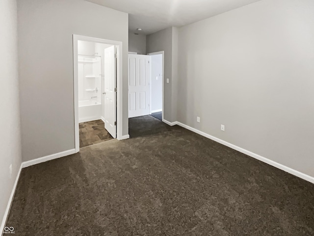 18230 Sandy Cove Ln, Westfield, IN 46074 - unfurnished bedroom with dark carpet, baseboards, and connected bathroom