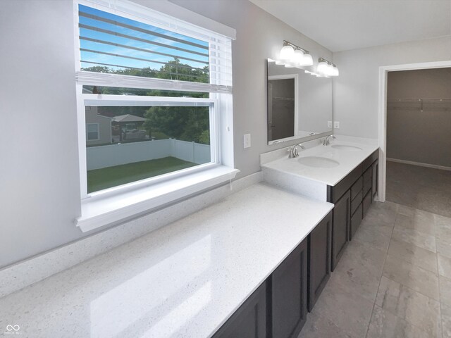 18230 Sandy Cove Ln, Westfield, IN 46074 - bathroom featuring a spacious closet, vanity, baseboards, and tile patterned floors