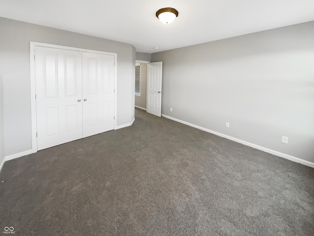 18230 Sandy Cove Ln, Westfield, IN 46074 - unfurnished bedroom with dark colored carpet, baseboards, and a closet