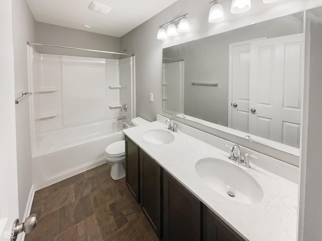 18230 Sandy Cove Ln, Westfield, IN 46074 - full bathroom featuring toilet, double vanity, stone finish floors, and shower / bathtub combination