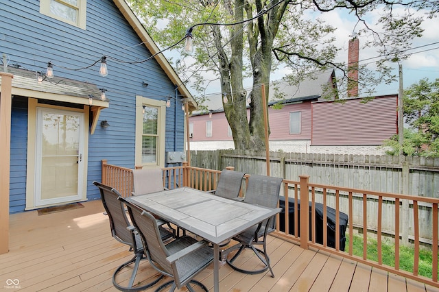 1009 Broadway St, Indianapolis, IN 46202 - wooden deck with outdoor dining area and a fenced backyard