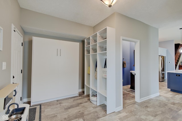 1009 Broadway St, Indianapolis, IN 46202 - mudroom with light wood-style floors, baseboards, and a textured ceiling