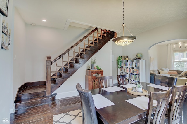 1009 Broadway St, Indianapolis, IN 46202 - dining area featuring wood finished floors, stairway, baseboards, arched walkways, and recessed lighting