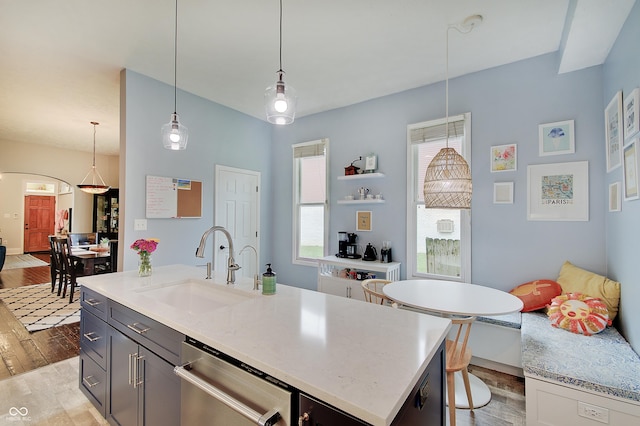 1009 Broadway St, Indianapolis, IN 46202 - kitchen with a sink, light wood finished floors, dishwasher, pendant lighting, and arched walkways