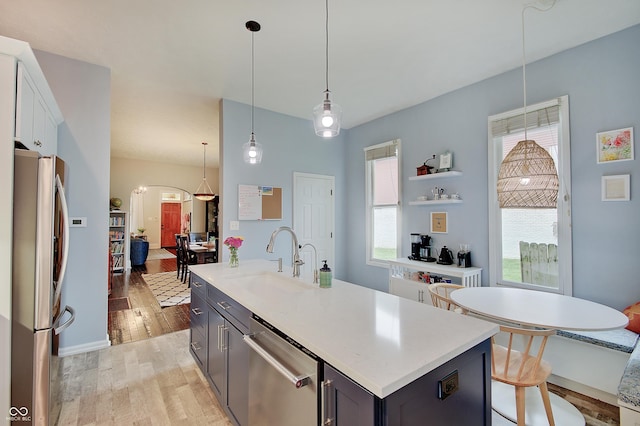 1009 Broadway St, Indianapolis, IN 46202 - kitchen featuring stainless steel appliances, a sink, light wood-style floors, and light countertops