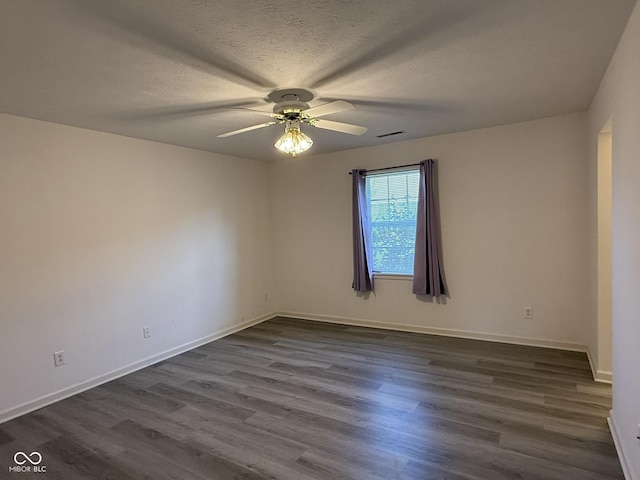 11523 Coastal Way, Indianapolis, IN 46229 - spare room featuring a ceiling fan, dark wood-style floors, baseboards, and a textured ceiling