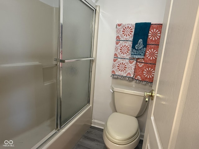 11523 Coastal Way, Indianapolis, IN 46229 - bathroom with wood finished floors, toilet, shower / bath combination with glass door, and baseboards