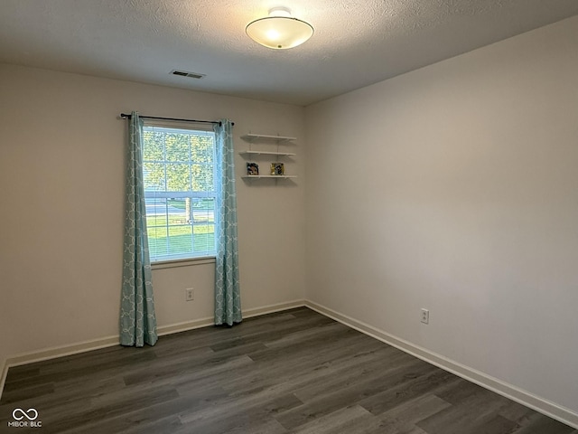 11523 Coastal Way, Indianapolis, IN 46229 - spare room with dark wood-type flooring, baseboards, and a textured ceiling