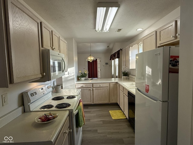 11523 Coastal Way, Indianapolis, IN 46229 - kitchen with white appliances, dark wood-type flooring, a textured ceiling, light countertops, and a chandelier