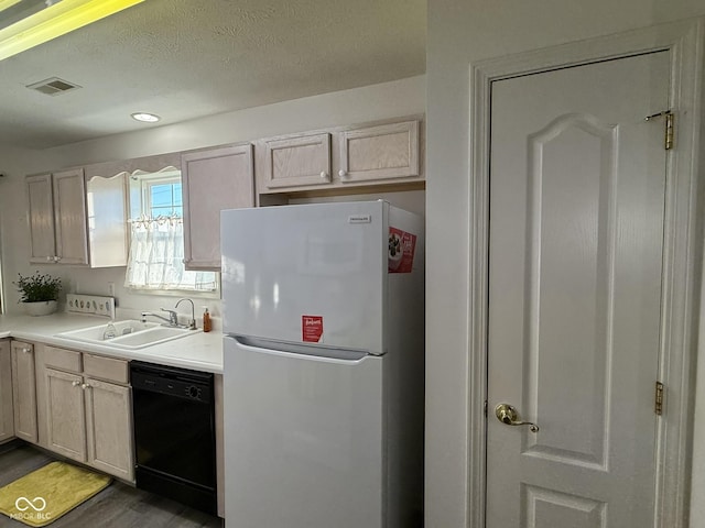 11523 Coastal Way, Indianapolis, IN 46229 - kitchen featuring freestanding refrigerator, black dishwasher, a sink, wood finished floors, and light countertops