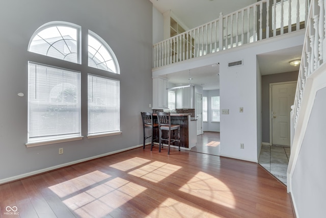 6542 E Edna Mills Dr, Camby, IN 46113 - living area featuring wood finished floors, baseboards, and a high ceiling