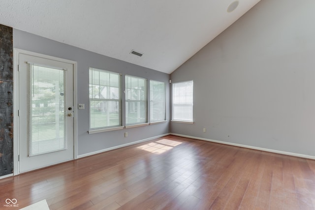 6542 E Edna Mills Dr, Camby, IN 46113 - empty room with wood finished floors, high vaulted ceiling, and baseboards