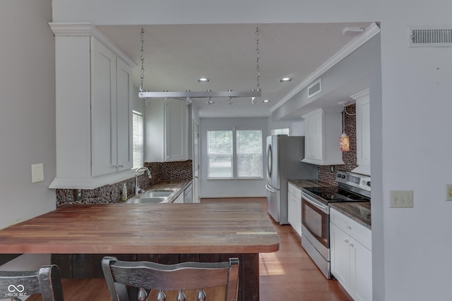 6542 E Edna Mills Dr, Camby, IN 46113 - kitchen featuring appliances with stainless steel finishes, a sink, tasteful backsplash, wood finished floors, and crown molding