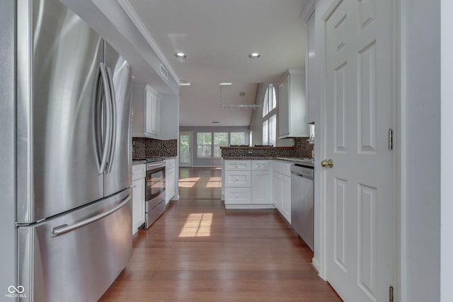 6542 E Edna Mills Dr, Camby, IN 46113 - kitchen featuring appliances with stainless steel finishes, dark wood-style flooring, decorative backsplash, white cabinets, and a peninsula