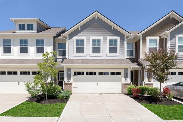 9604 Beckett St, Avon, IN 46123 - view of property featuring concrete driveway, an attached garage, and brick siding