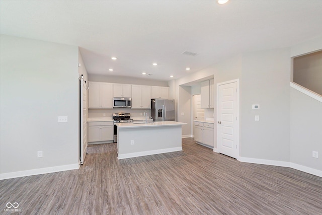 9604 Beckett St, Avon, IN 46123 - kitchen with stainless steel appliances, light wood finished floors, a sink, baseboards, and recessed lighting