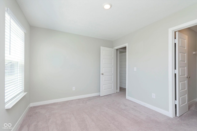 9604 Beckett St, Avon, IN 46123 - unfurnished bedroom featuring multiple windows, light colored carpet, and baseboards