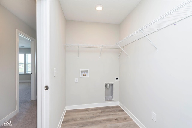 9604 Beckett St, Avon, IN 46123 - clothes washing area featuring hookup for a washing machine, baseboards, hookup for an electric dryer, and light wood-style flooring