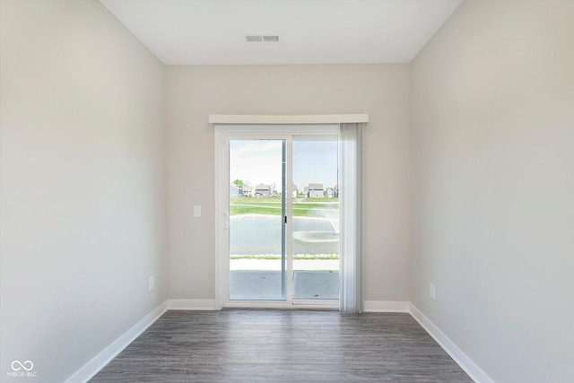 9604 Beckett St, Avon, IN 46123 - spare room featuring baseboards, dark wood-type flooring, and plenty of natural light