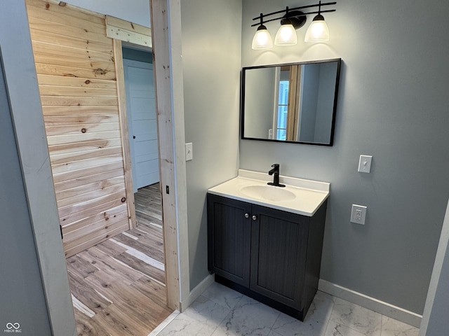 671 E Bethel Rd, Attica, IN 47918 - bathroom featuring baseboards, marble look tile flooring, vanity, and wooden walls