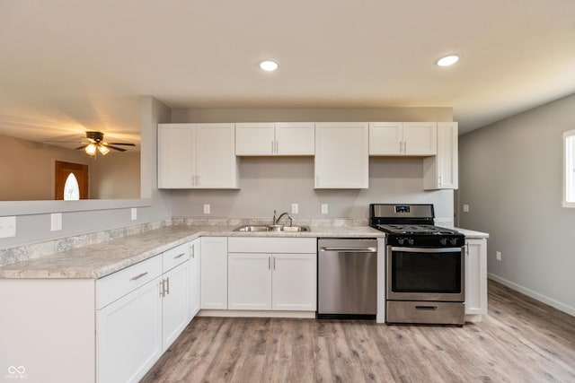 521 Sunset Dr, Edinburgh, IN 46124 - kitchen featuring appliances with stainless steel finishes, white cabinets, light wood-style floors, a ceiling fan, and light countertops