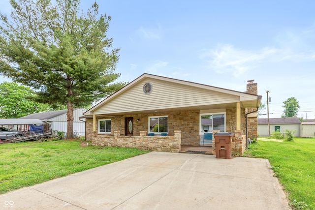521 Sunset Dr, Edinburgh, IN 46124 - view of front of property featuring a chimney, a front lawn, stone siding, and a patio