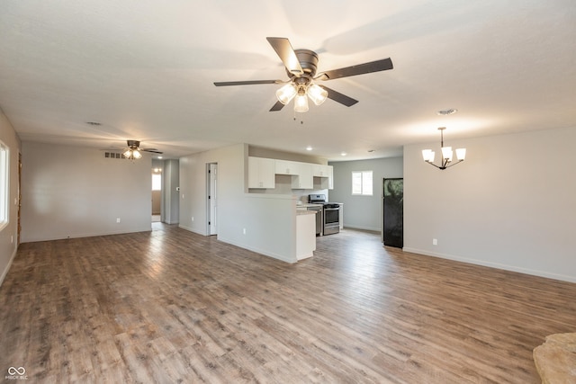 521 Sunset Dr, Edinburgh, IN 46124 - unfurnished living room featuring ceiling fan, a chandelier, wood finished floors, and baseboards