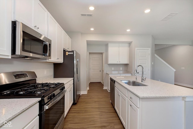 1280 Newton St, Avon, IN 46123 - kitchen with stainless steel appliances, a sink, baseboards, a kitchen island with sink, and white cabinets