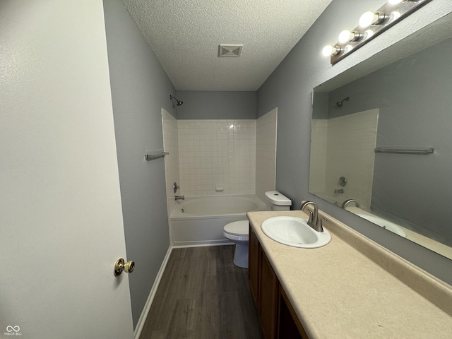 9145 Blue Pine Dr, Indianapolis, IN 46231 - bathroom featuring toilet, shower / bath combination, a textured ceiling, wood finished floors, and vanity