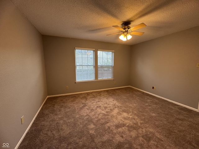 9145 Blue Pine Dr, Indianapolis, IN 46231 - spare room featuring a ceiling fan, a textured ceiling, dark colored carpet, and baseboards