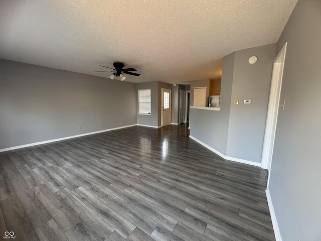 9145 Blue Pine Dr, Indianapolis, IN 46231 - unfurnished living room with a textured ceiling, ceiling fan, dark wood-style floors, and baseboards