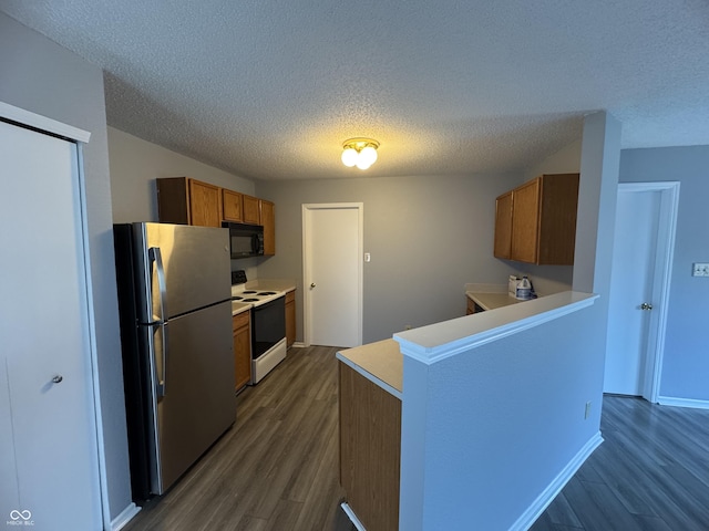 9145 Blue Pine Dr, Indianapolis, IN 46231 - kitchen featuring freestanding refrigerator, range with electric stovetop, black microwave, brown cabinetry, and dark wood finished floors