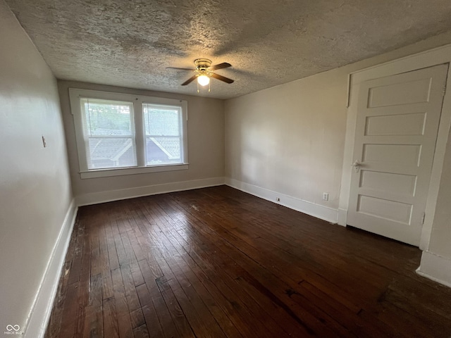 1137 W 34th St, Indianapolis, IN 46208 - spare room with a ceiling fan, dark wood-style flooring, baseboards, and a textured ceiling
