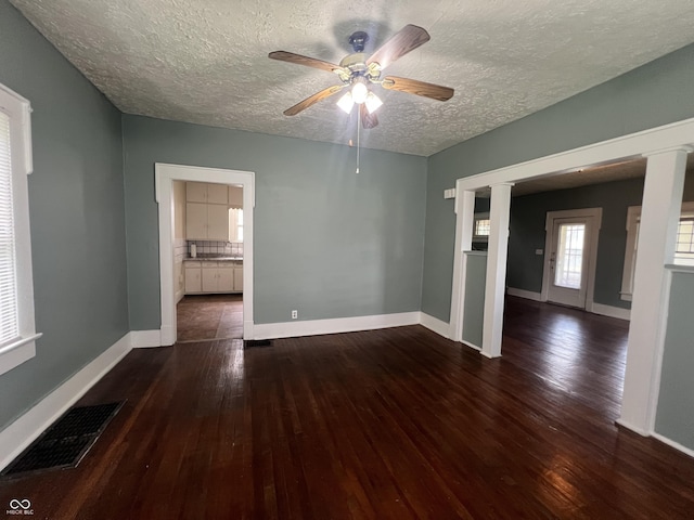 1137 W 34th St, Indianapolis, IN 46208 - spare room featuring hardwood / wood-style flooring, a textured ceiling, a ceiling fan, and baseboards