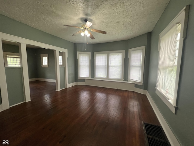 1137 W 34th St, Indianapolis, IN 46208 - spare room featuring wood finished floors, ceiling fan, baseboards, and a textured ceiling