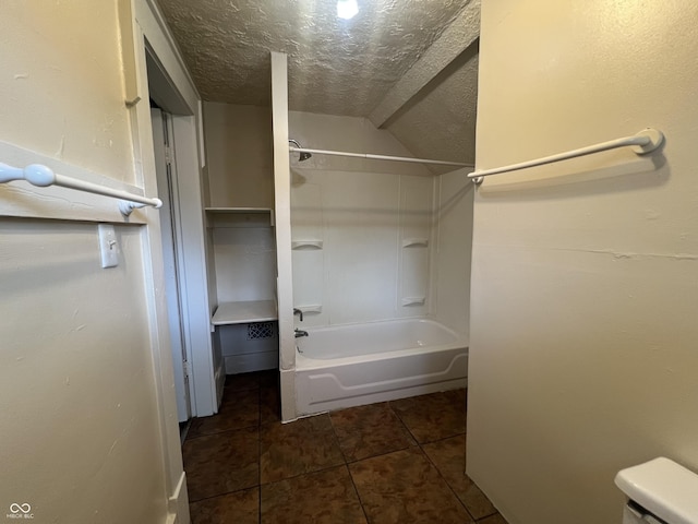 1137 W 34th St, Indianapolis, IN 46208 - bathroom featuring tile patterned flooring, tub / shower combination, toilet, and a textured ceiling