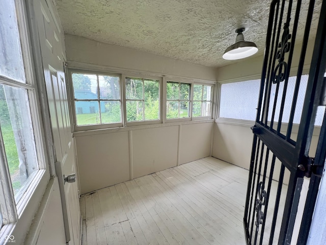 1137 W 34th St, Indianapolis, IN 46208 - unfurnished sunroom with a textured ceiling and wood-type flooring