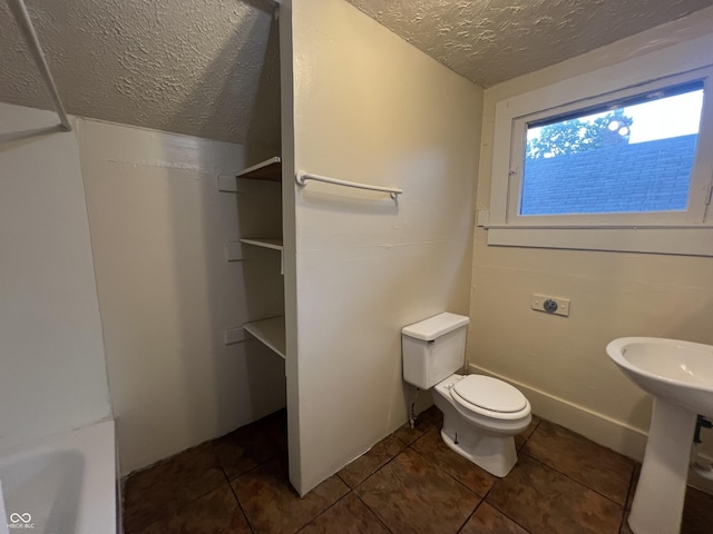 1137 W 34th St, Indianapolis, IN 46208 - bathroom featuring a textured ceiling, toilet, and tile patterned floors