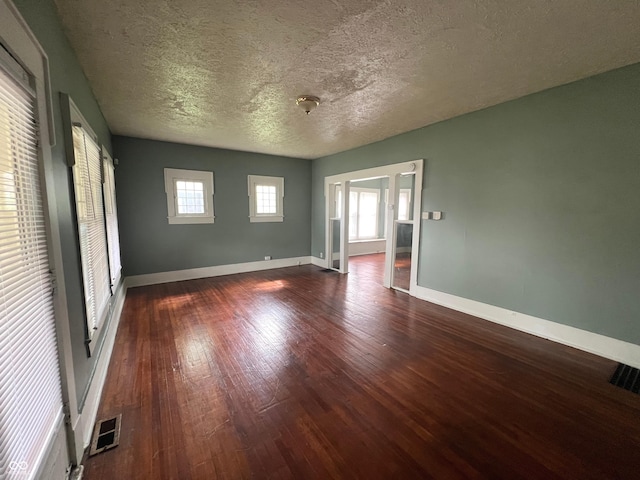 1137 W 34th St, Indianapolis, IN 46208 - spare room with wood finished floors, a textured ceiling, and baseboards