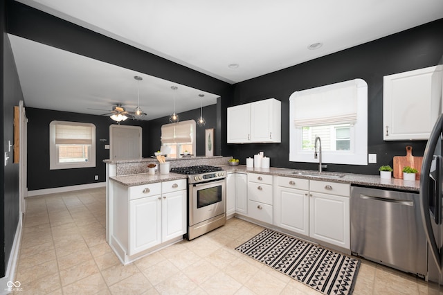 117 S Spencer Ave, Indianapolis, IN 46219 - kitchen with appliances with stainless steel finishes, a sink, a peninsula, white cabinetry, and a ceiling fan