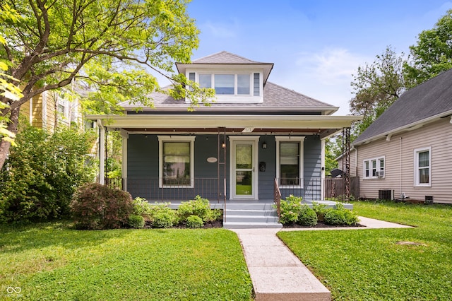117 S Spencer Ave, Indianapolis, IN 46219 - view of front of property featuring a porch, central air condition unit, a front lawn, and roof with shingles