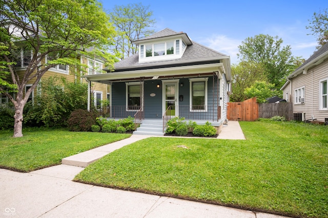 117 S Spencer Ave, Indianapolis, IN 46219 - view of front facade with covered porch, a shingled roof, and central air condition unit