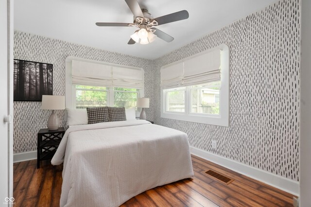 117 S Spencer Ave, Indianapolis, IN 46219 - bedroom with wallpapered walls, wood finished floors, baseboards, and a ceiling fan