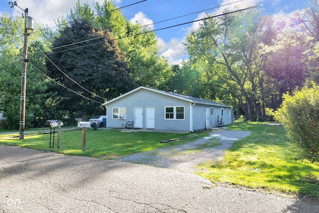 6017 Bluff Crest Ct, Indianapolis, IN 46217 - view of side of property with a yard, driveway, and view of scattered trees