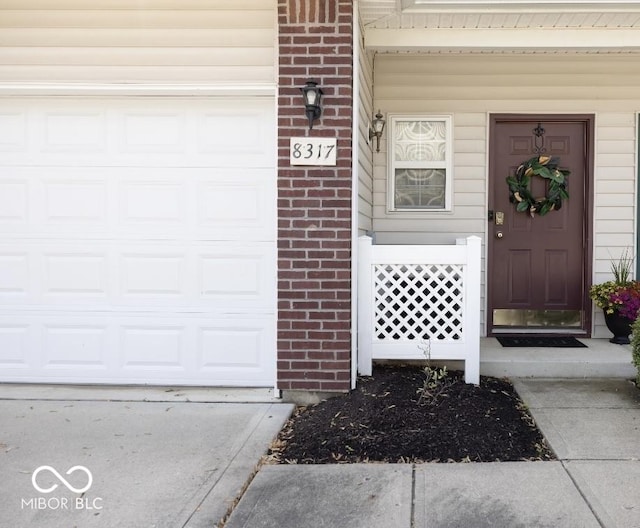 8317 Pine Branch Ln, Indianapolis, IN 46234 - property entrance featuring brick siding and an attached garage
