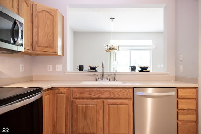 8317 Pine Branch Ln, Indianapolis, IN 46234 - kitchen with stainless steel appliances, a sink, light countertops, and a chandelier