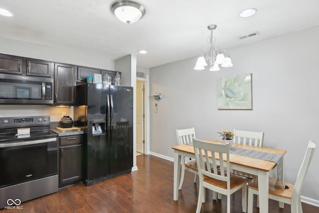 2911 W Hawanian Ln, Monrovia, IN 46157 - kitchen with stainless steel appliances, dark wood-style floors, a chandelier, hanging light fixtures, and baseboards