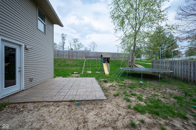 917 Timothy Ct, Bloomington, IN 47403 - view of yard featuring a trampoline, a playground, and a patio