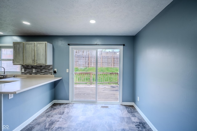917 Timothy Ct, Bloomington, IN 47403 - kitchen with a textured ceiling, baseboards, healthy amount of natural light, a sink, and recessed lighting
